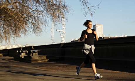 A woman jogs in the morning sunshine