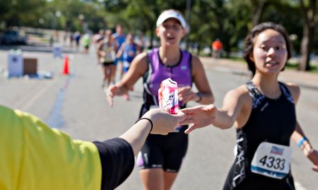 Marathon runner reaching for an energy gel packet