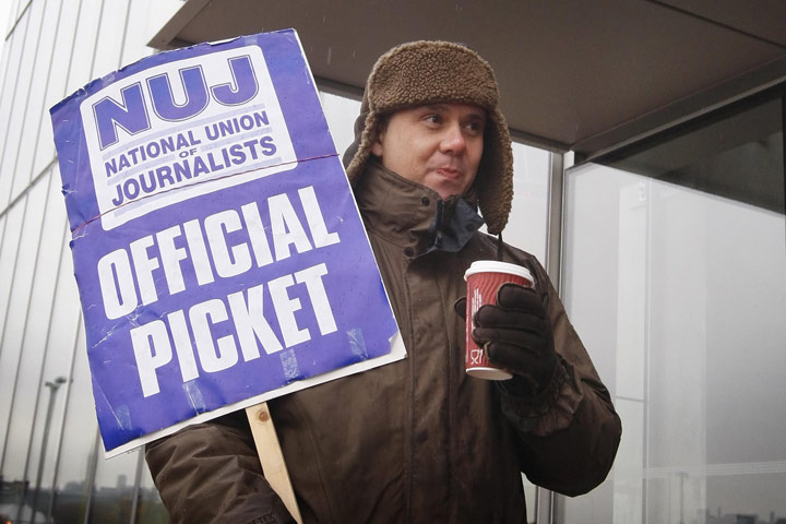 BBC strike: A striker braves the rain on the NUJ picket line in Glasgow