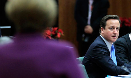 David Cameron looks at Germany's chancellor Angela Merkel