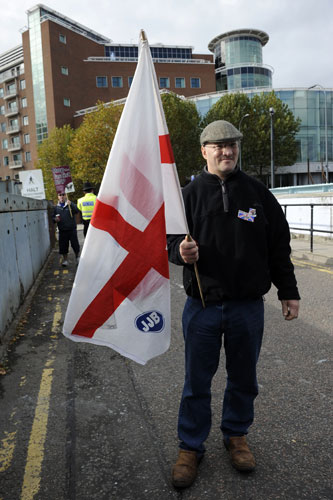 Question Time protests: A BNP supporter with the flag of St George opposite BBC Television Centre