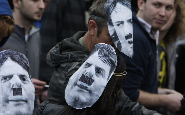 Question Time protests: Protesters wearing masks depicting BNP leader Nick Griffin as Adolf Hitler