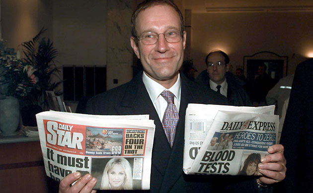 Richard Desmond: Richard Desmond with copies of the Star and Express