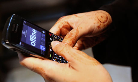 A woman uses her Blackberry 