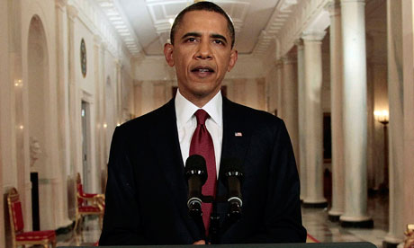 President Barack Obama reads his statement to photographers
