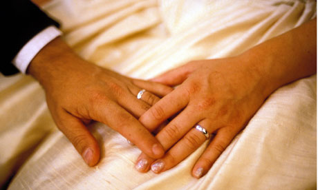 A newlywed couple hold hands