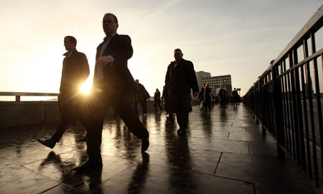 City workers walk across London Bridge