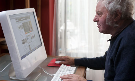 Elderly man at home using a computer