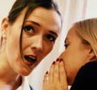 Woman whispers to a colleague