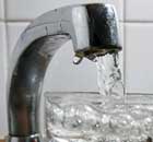 Tap water filling a glass