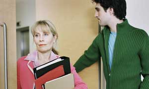A man opens the door for a female colleague