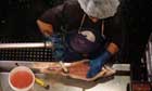 A woman gutting fish