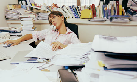 Woman sitting at messy desk