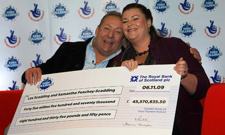A giant cheque in the hands of lottery winners the Scaddings