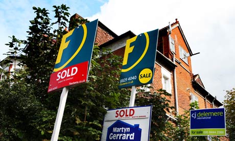 Estate agent signs outside a property in north London.