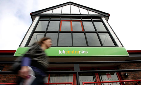 A woman walking past a Job Centre