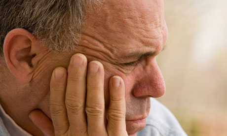 A man looking depressed due to workplace bullying