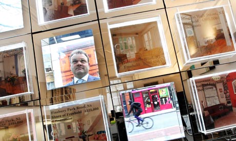 A man looking in an estate agent window