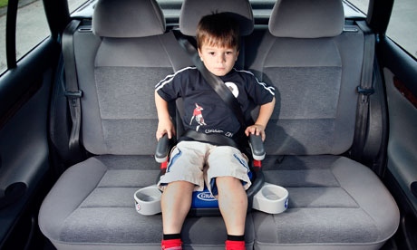 A boy in a car booster seat