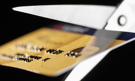 Some scissors cutting up a credit card