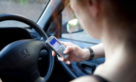A woman using her mobile while driving