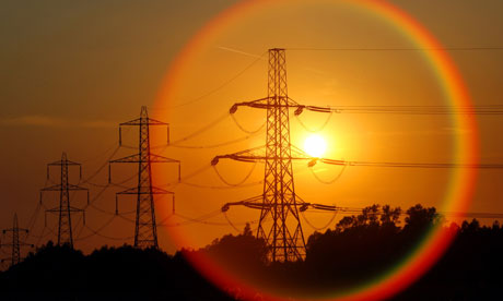 The sun sets behind pylons in central England