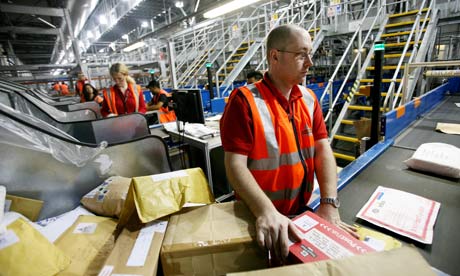Postal workers sort packages
