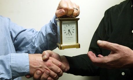 A man getting a handshake and carriage clock as he retires