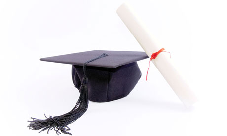 A mortar board hat and diploma