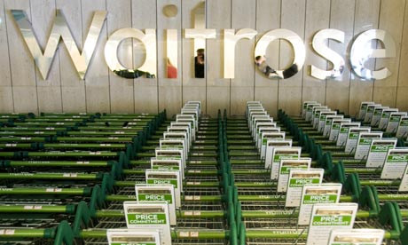 A Waitrose sign and rows of trolleys