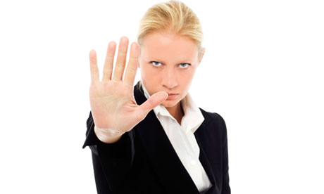 portrait of a young caucasian businesswoman with aggressive air wearing a jacket.