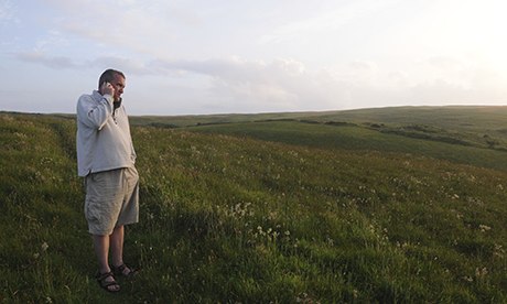Man talking on a mobile phone in a field