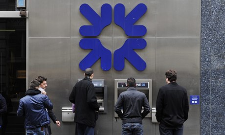 Customers next to an RBS ATM