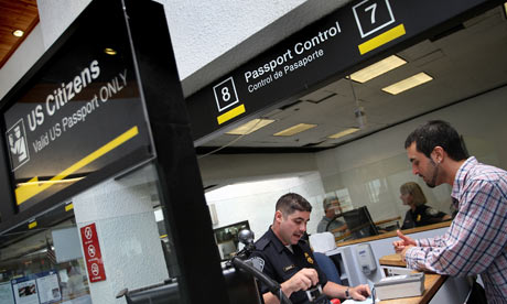 A border protection officer checks passports in the US