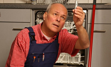 Workman repairs diswasher