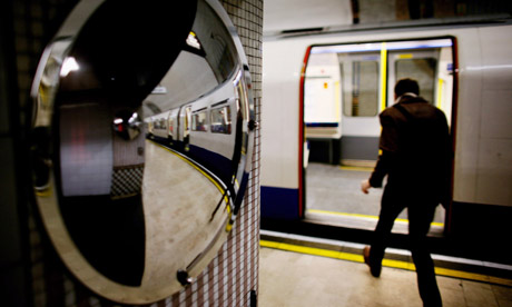 A man gets into a London Underground tube train