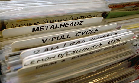Man searches through racks of vinyl at a record shop