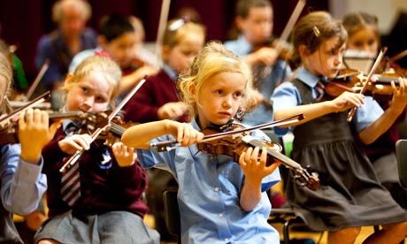 photograph of young children playing violins