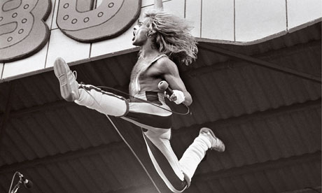 David Lee Roth, of Van Halen, performing live onstage, jumping.