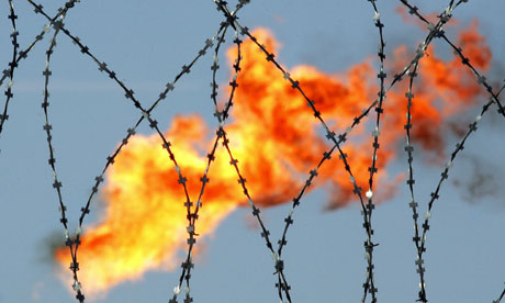 A gaz flare behind barbed wire at Rosneft plant
