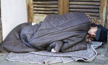 Homeless person sleeping rough in a doorway