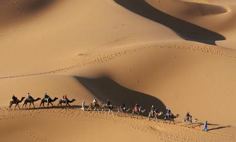 Take a camel ride in Morocco's Atlas Mountains.
