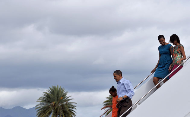 Obs Obamas on holiday: The Obamas disembark from Air Force One at Honolulu on Christmas Eve