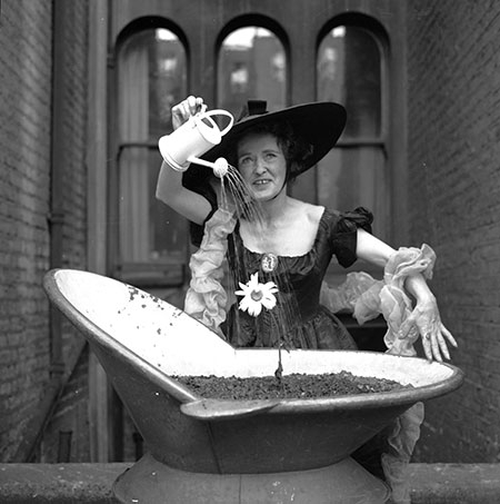 Ken Russell: Ken Russell photo of a ady in costume watering her flowers