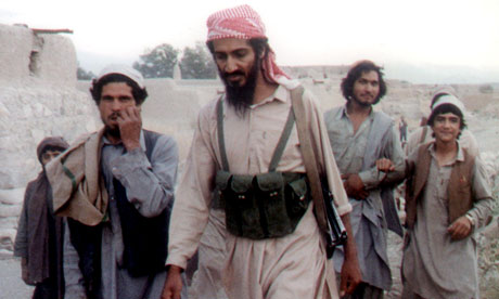 Osama Bin Laden walks with Bin Laden center walks with. Osama Bin Laden walks with