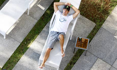 Jenson Button relaxes on a sunlounger