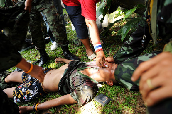 Thailand protests: A Thai soldier lies on the ground