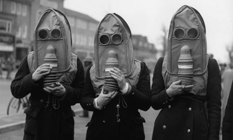 Three air raid wardens wearing gas masks Three air raid wardens wearing a 