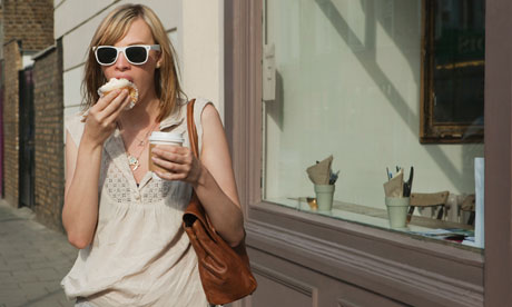 Woman eating in street