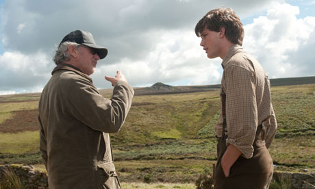 Steven Spielberg directs Jeremy Irvine on location in Devon during the filming of War Horse.